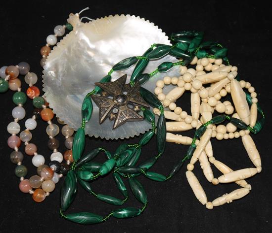 An agate bead necklace, a malachite necklace an ivory necklace a carved shell and pique cross brooch (a.f.).